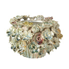 Glazed ceramic pot with 3D floral petals in sage green and earthy tones against a white background.