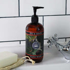 Fig and Grape hand wash bottle styled on a white tiled bathroom sink next to a white soap bar and natural loofah.