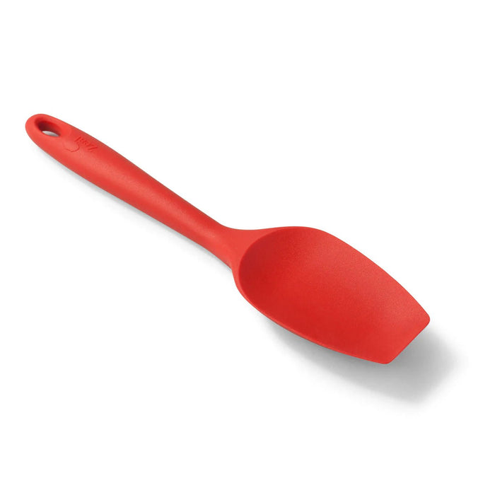 Red large silicone spatula spoon with flat end and ergonomic handle on a white background