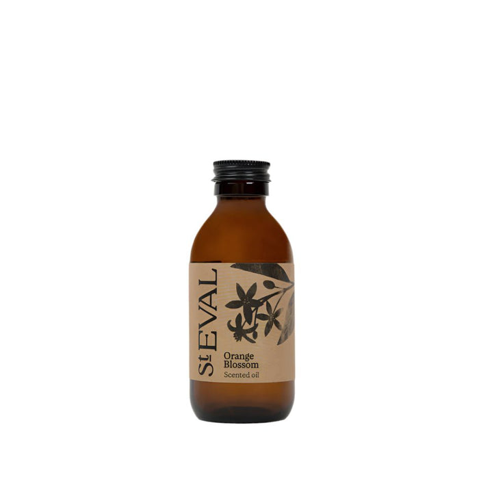 Amber glass bottle of Orange Blossom scented oil refill with a decorative floral label