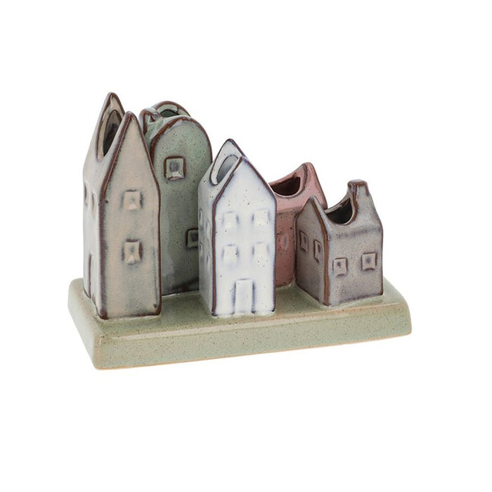 Glazed pottery vase featuring five multi-coloured house shapes in pastel green, cream, and pink tones.