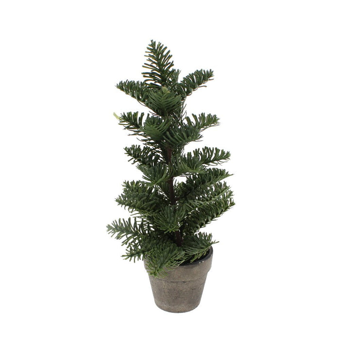 Small artificial Nordic spruce tree in a grey ceramic pot against a white background