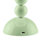Detail of the USB-C charging port located at the base of the lacquered sage green lamp