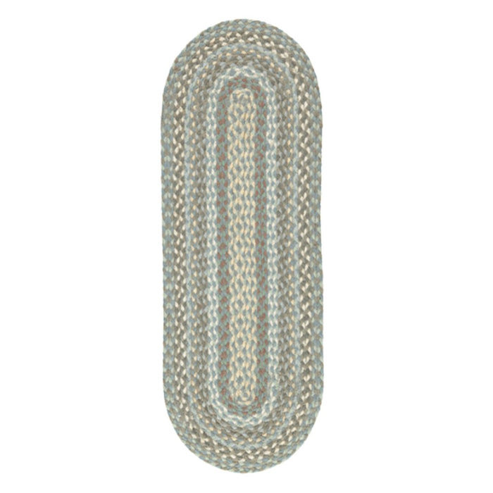 Oval braided jute table runner with coastal tones of blue, grey and sand