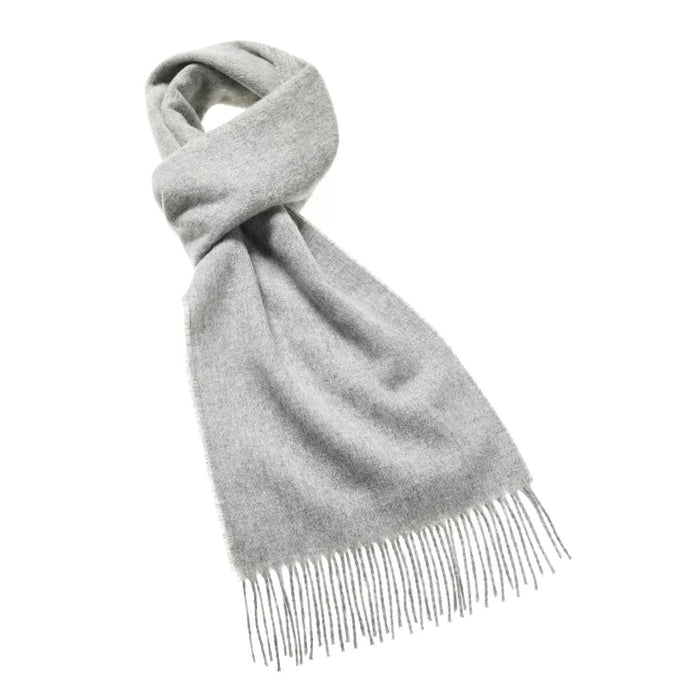 Knotted silver grey merino wool scarf with fringed edges against a white background