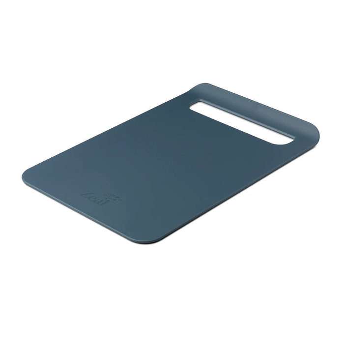 Dark blue slim chopping board with integrated carry handle and transfer chute