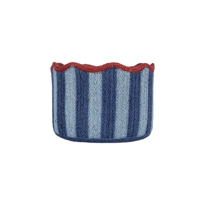 Handcrafted jute basket with navy and pale blue vertical stripes and a red scalloped edge against a white background.
