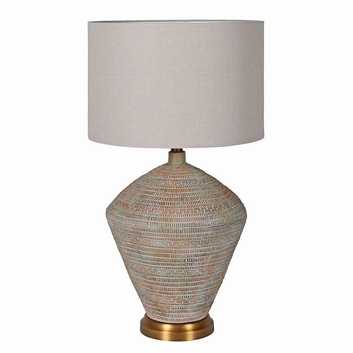 Valencia table lamp with a textured pottery base, bronze detail and neutral linen shade against a white background