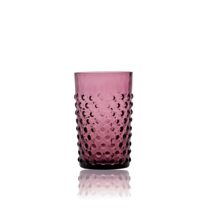 A violet crystal hobnail tumbler showing the tactile raised glass texture on a white reflective surface.