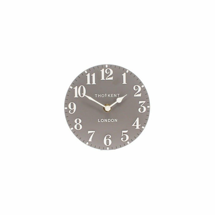 Front view of a circular dolphin grey mantel clock with white Arabic numerals and hands