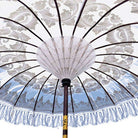 Interior view of the parasol ribs and hand-woven white string webbing supporting the printed fabric.