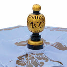 Detail shot of the hand-carved wooden top finial finished in gold and black paint.