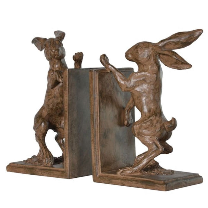 A pair of resin boxing hare bookends facing each other on a white background