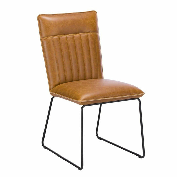 Modern tan faux leather dining chair with vertical stitching and black metal sledge legs.