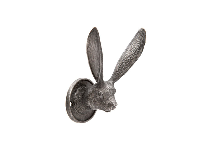 Pewter metal wall hook in the shape of a hare head with long ears and a circular mounting plate.