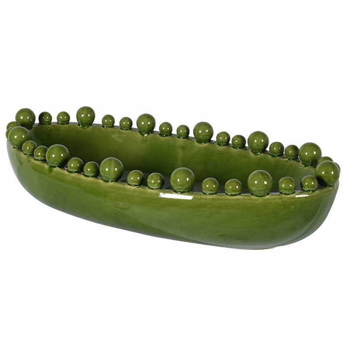 Oval green ceramic bowl with variable-sized decorative bobbles around the rim on a white background