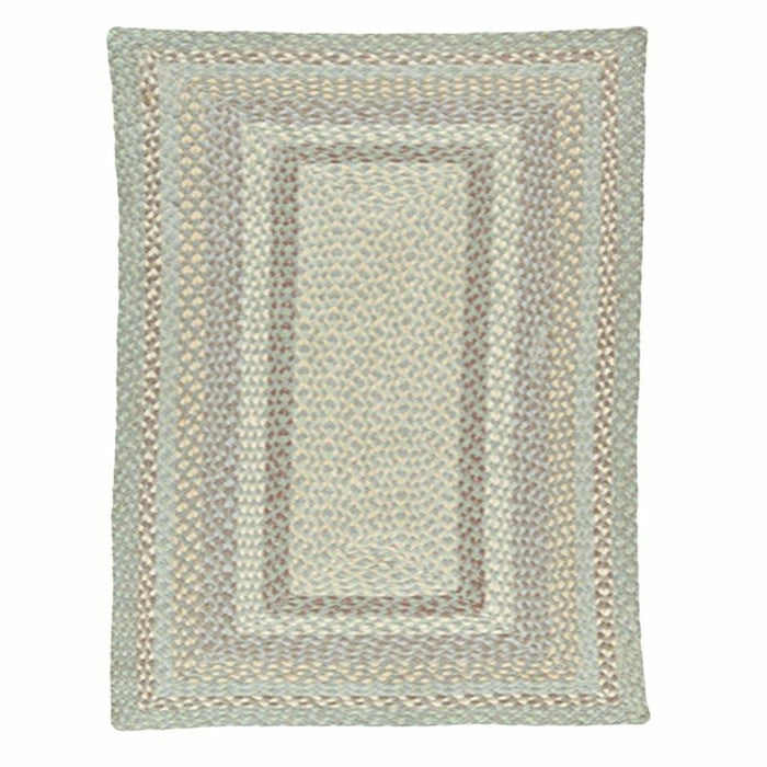 Rectangular Seaspray Jute Rug showing concentric braided patterns in soft green and sandy beige tones.