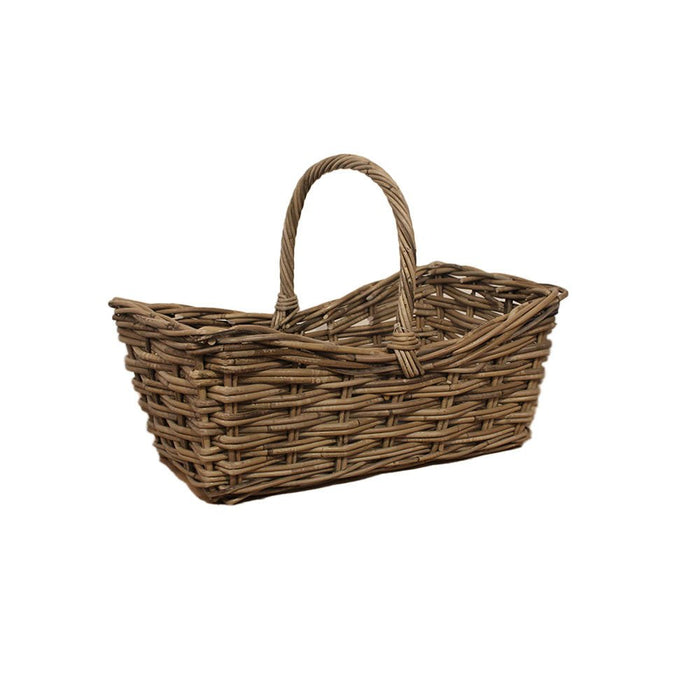 A small rectangular handwoven rattan shopping basket with a single tall curved handle seen from an angle.