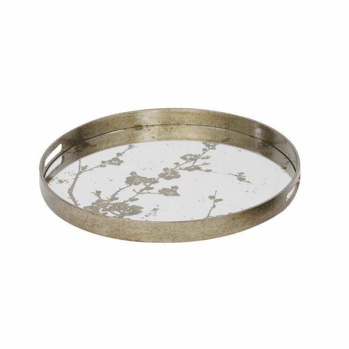 Small circular antique gold tray with a mirrored glass base and a delicate blossom branch motif.